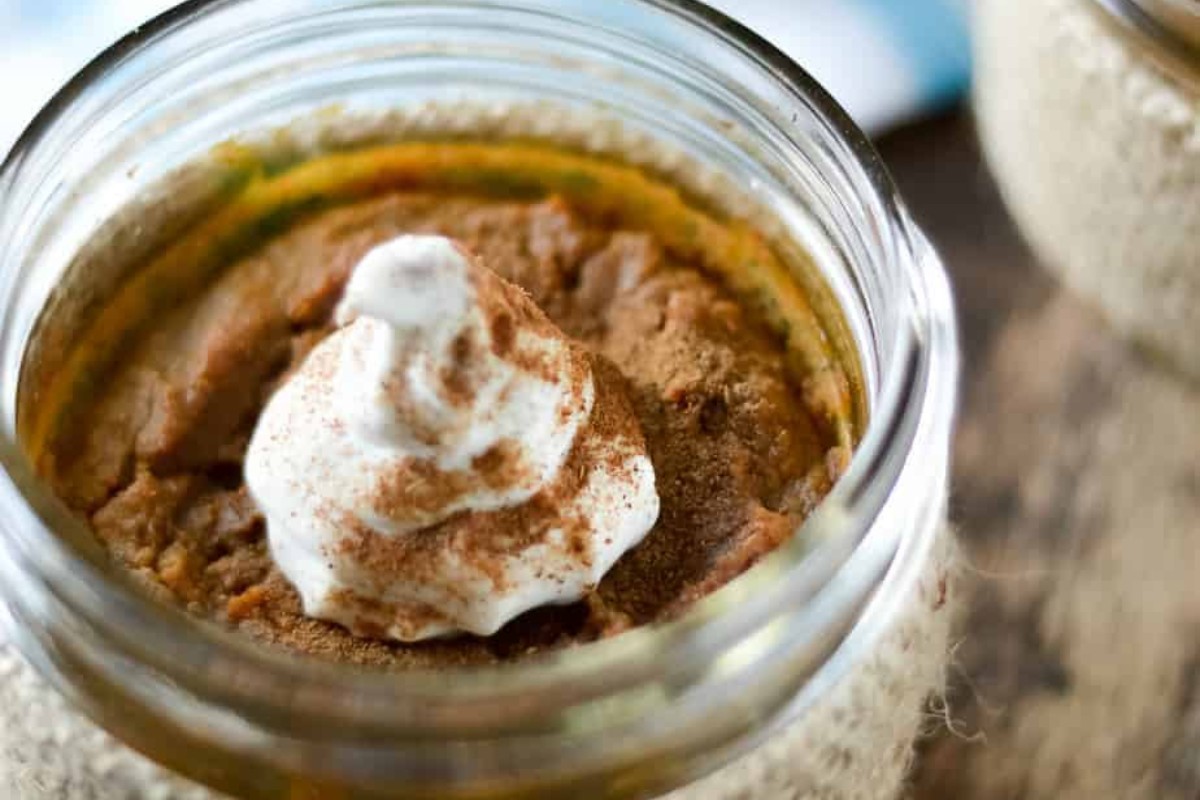 A glass jar with a crustless pumpkin pie.