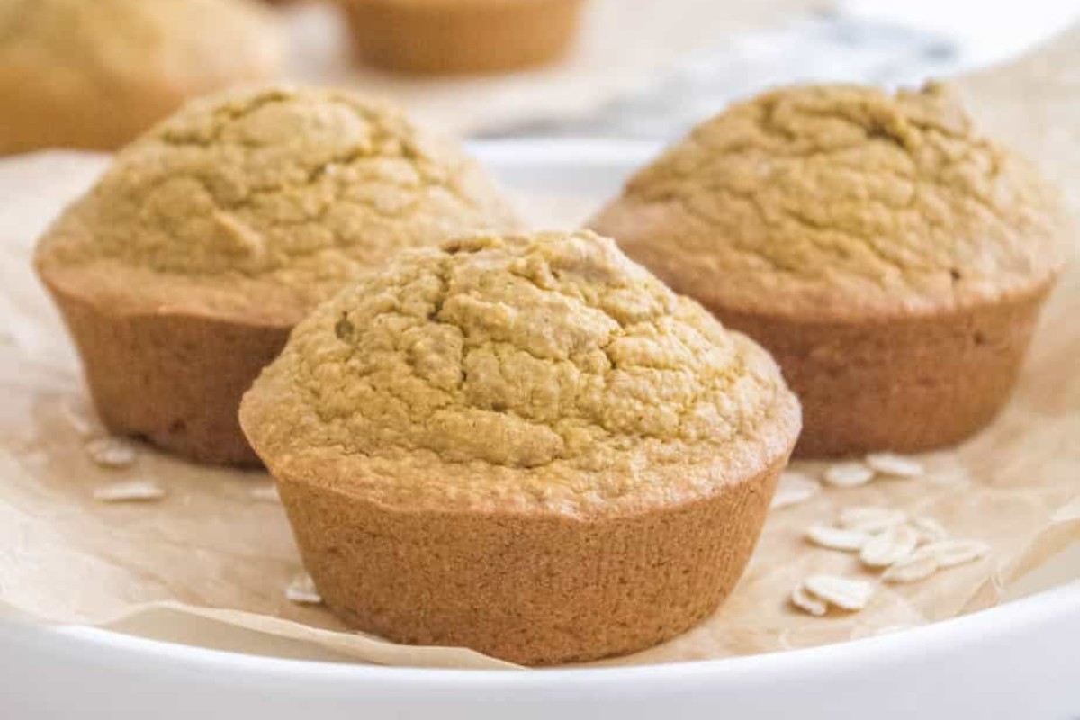 A white plate with 3 oat flour pumpkin muffins. 
