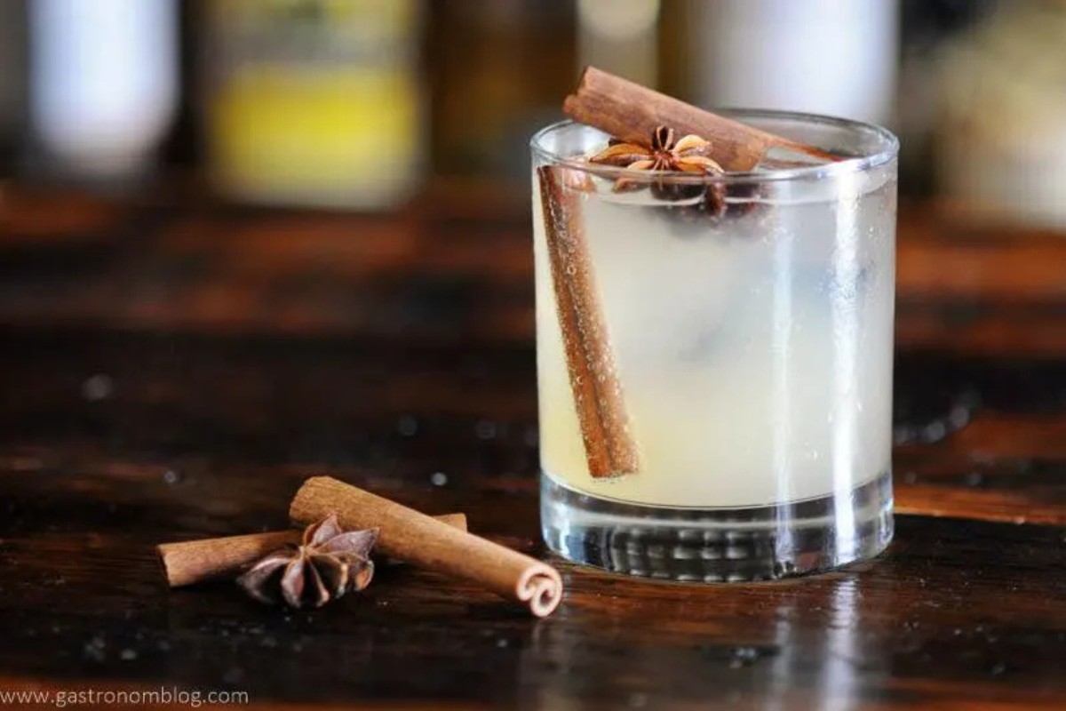 A glass filled with a Fall gin and tonic cocktail.