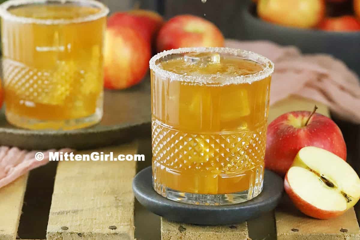 Two glasses filled with caramel apple vodka cocktail.