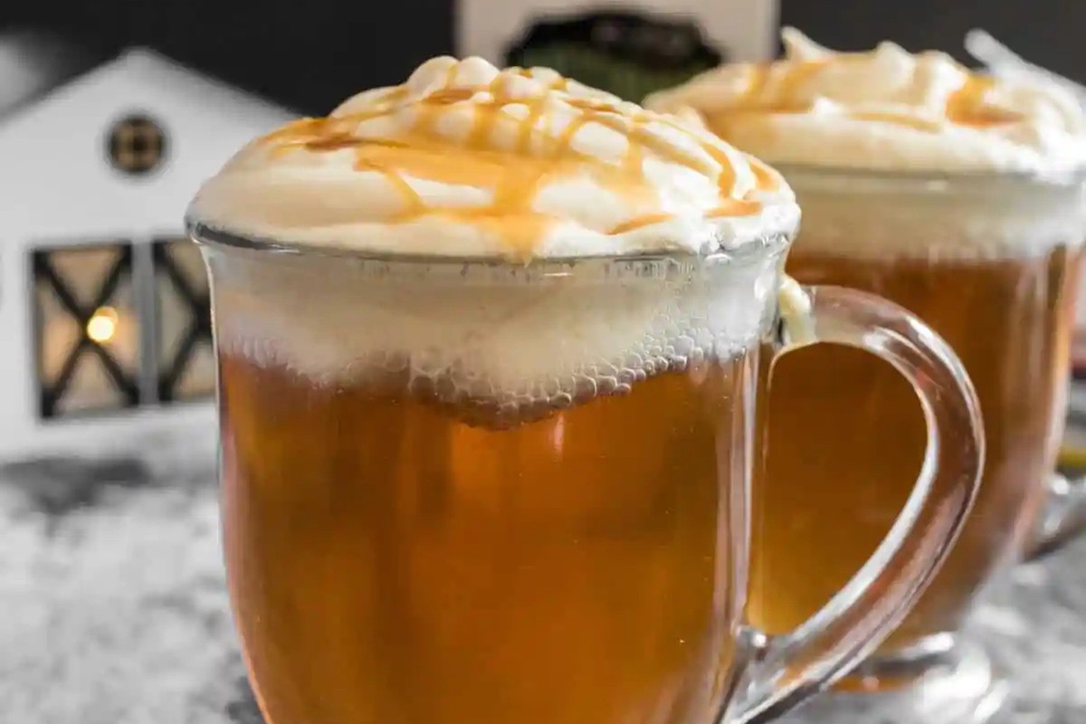 Two glasses filled with Harry Potter Butterbeer. 